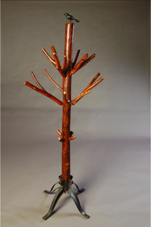 hickory coat rack resembling a tree with bare branches and black ornamental bird