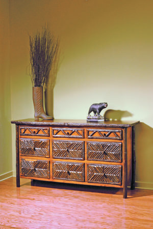 wide 9 drawer dresser with ornate hickory wood pattern on drawer faces