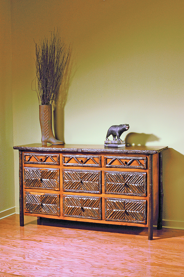 wide 9 drawer dresser with ornate hickory wood pattern on drawer faces