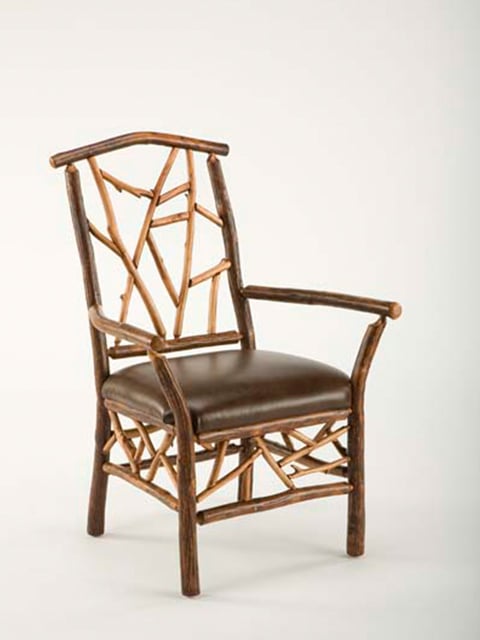 woodsman arm chair with leather seat and branch accents
