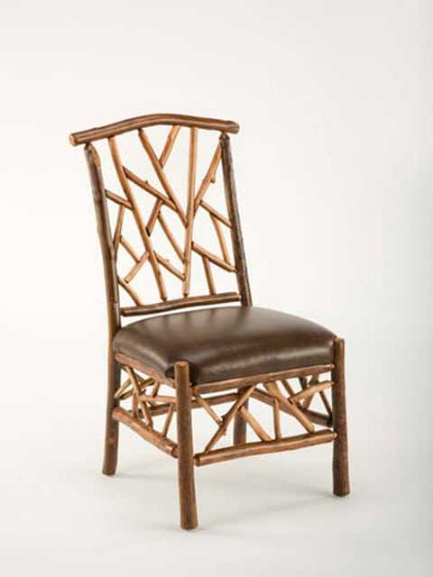 woodsman side chair with leather seat and branch accents on back