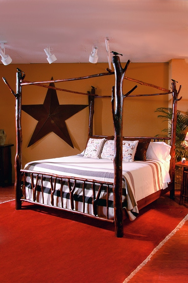 four poster canopy bed with large slingshot accents in bedroom
