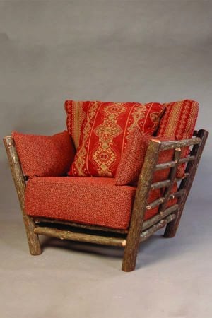 loft chair with rustic bark arms and red cushions