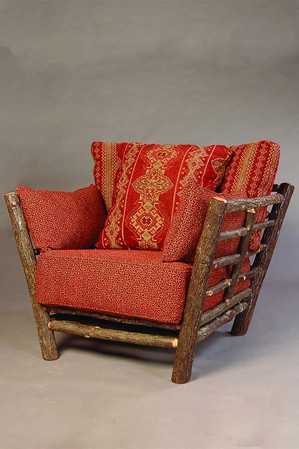 loft chair with rustic bark arms and red cushions