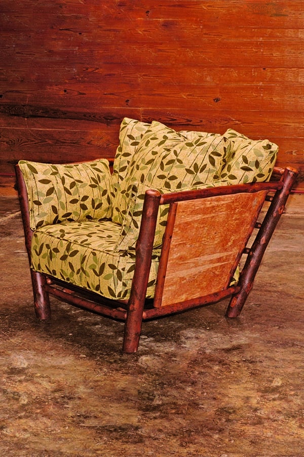 birch bark loft chair with patterned yellow cushions