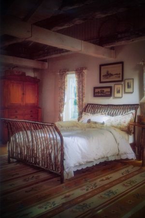 sleigh bed with curved branches on headboard and footboard