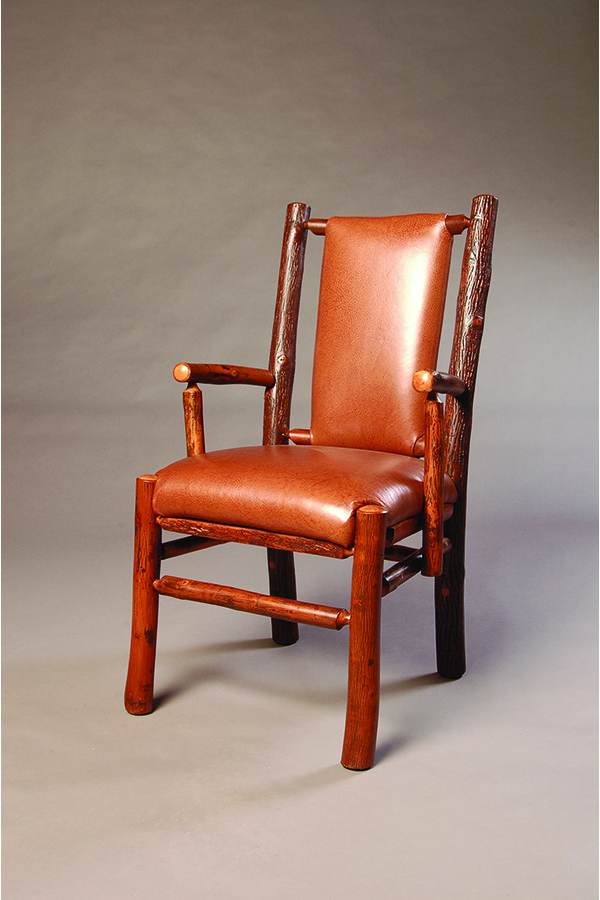 recessed arm chair with log frame and leather upholstery