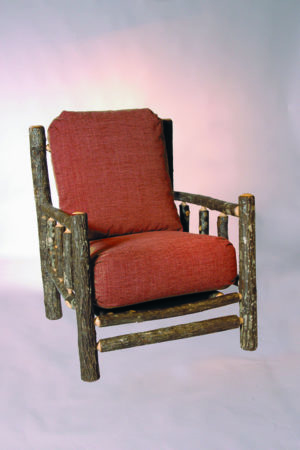 camp chair with rustic bark frame and red cushions