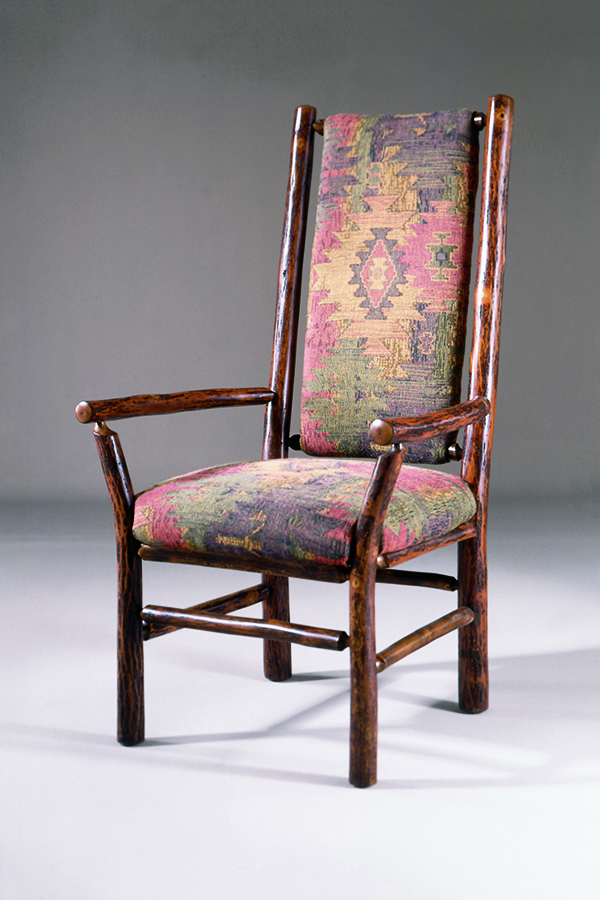high back arm chair with aztec patterned upholstery on back and seat