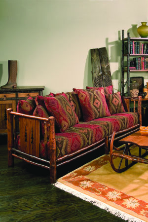 pine tree 3 person sofa with carved tree sides and upholstery with pillows