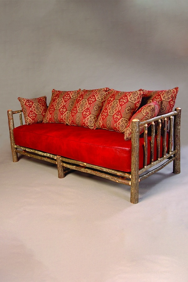 three person sofa with log frame and red cushions